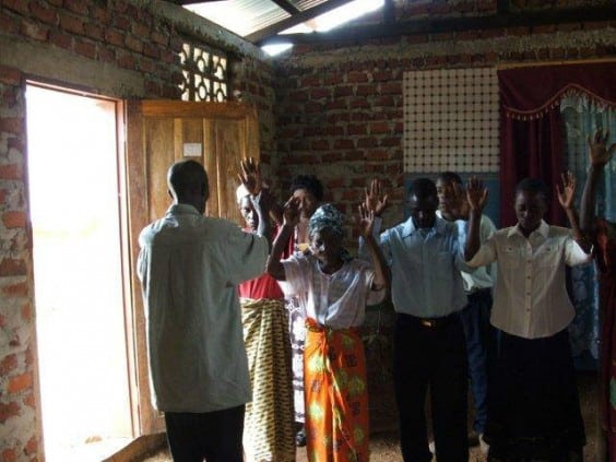 misheck-praying-for-people-in-a-rural-church
