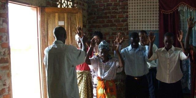 misheck-praying-for-people-in-a-rural-church